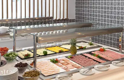 a buffet line with different types of food at The Blue Ivy Hotel & Suites in Protaras