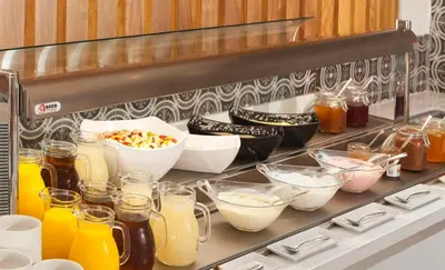 a shelf with different types of food and drinks at The Blue Ivy Hotel & Suites in Protaras