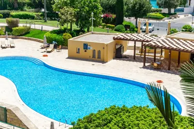 an image of a swimming pool in front of a house at Limassol Marina Nereids D22 by Ezoria Villas in Limassol