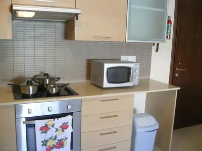 a kitchen with a microwave oven and a stove at Pyla Gardens E107 in Pyla