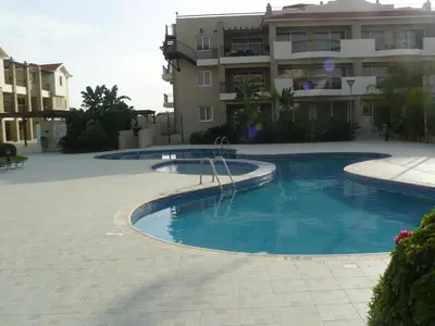 a large swimming pool in front of a building at Pyla Gardens E107 in Pyla