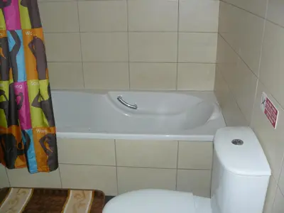a bathroom with a toilet and a bath tub at Pyla Gardens E107 in Pyla