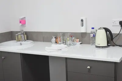 a white counter top with a sink and a sink at Rimon Cyprus Israeli Kosher Rooms in Larnaka