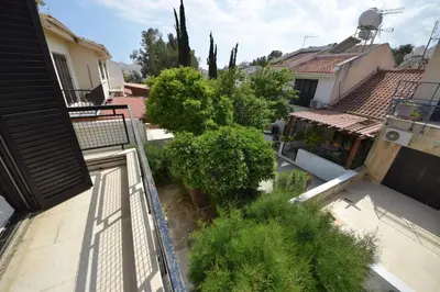 a view from the balcony of a house with a tree at Christos beach house in Larnaka