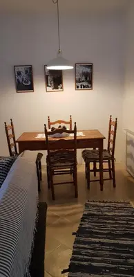a dining room with a wooden table and chairs at Kalopanayiotis Museum Inn in Kalopanayiotis