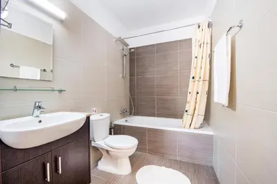 a bathroom with a sink and a toilet and a tub at Mythical Sands Apartments in Protaras
