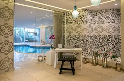 a bathroom with a table and a swimming pool at Vangelis Hotel & Suites in Protaras