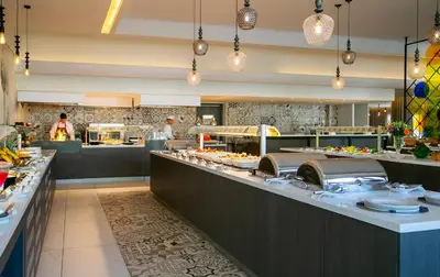 a restaurant with a buffet line of food at Vangelis Hotel & Suites in Protaras