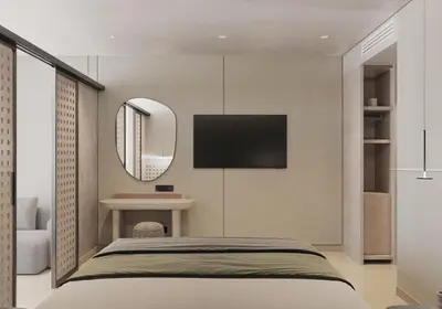 a bedroom with a bed and a mirror and a tv at Sun Palace Protaras Waterpark Resort in Protaras