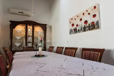 a dining room with a table with a candle on it at Samareitidos Light Cottage in Anaphotia