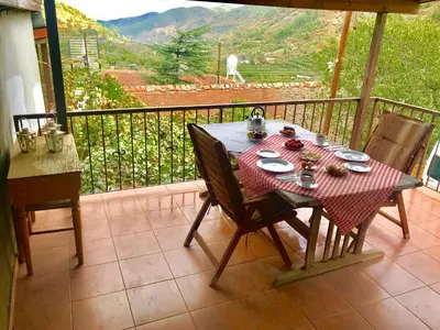 a table and chairs on a balcony with a view at Saint Nicholas heights in Chakistra