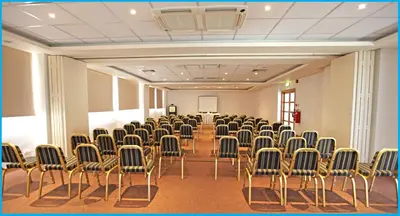 a room with rows of chairs and a podium in it at Poseidonia Beach Hotel in Limassol