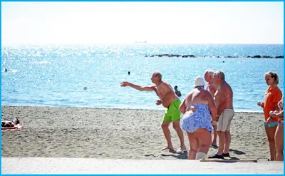 a group of people playing frisbee on the beach at Poseidonia Beach Hotel in Limassol