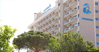a hotel with the crest of a hotel at Poseidonia Beach Hotel in Limassol