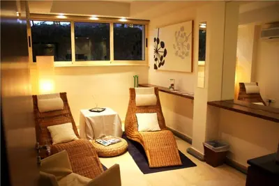 a room with wicker chairs and a table and window at E-Hotel Larnaca Resort & Spa in Larnaka