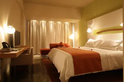 a hotel room with a bed and a desk at E-Hotel Larnaca Resort & Spa in Larnaka