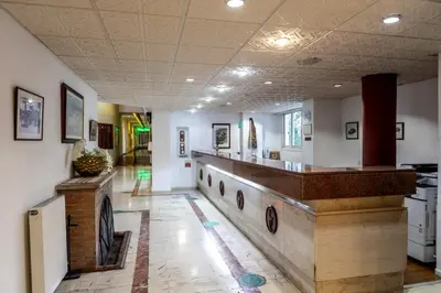 a room with a hallway with a row of dishes on the wall at Forest Park Hotel in Platres