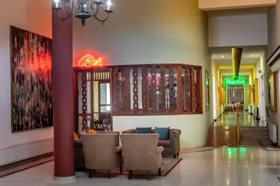 a lobby with chairs and a sign in a building at Forest Park Hotel in Platres