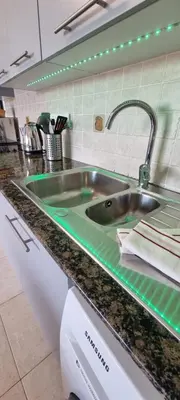 a kitchen sink with a green counter top at Mazotos Hills 3 in Mazotos
