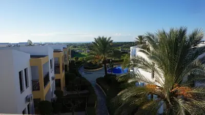 an aerial view of buildings and palm trees at Mazotos Hills 3 in Mazotos