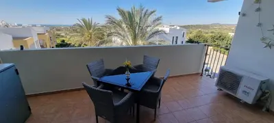 a table and chairs on a balcony with a view at Mazotos Hills 3 in Mazotos