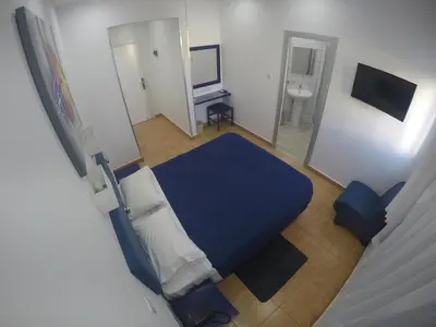 an overhead view of a bedroom with a blue bed at Asty Hotel in Nicosia