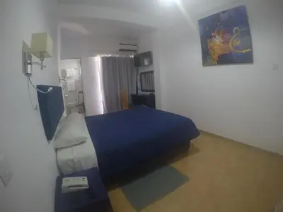 a bedroom with a bed with a blue blanket at Asty Hotel in Nicosia