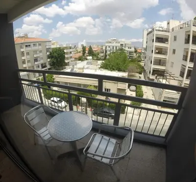 a balcony with a table and chairs and a view at Asty Hotel in Nicosia