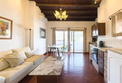 a living room with a couch and a table at Kalavasos Square Apartments - With Access to Shared Pool 3 Minutes Walk in Kalavasos