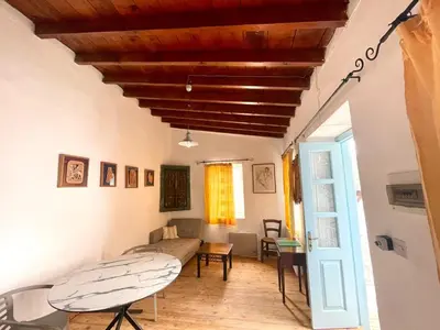 a room with a bed and a table and chairs at Kalavasos Square Apartments - With Access to Shared Pool 3 Minutes Walk in Kalavasos