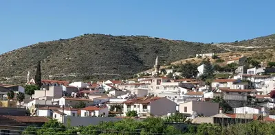 a group of houses on a hill with a mountain at Kalavasos Square Apartments - With Access to Shared Pool 3 Minutes Walk in Kalavasos