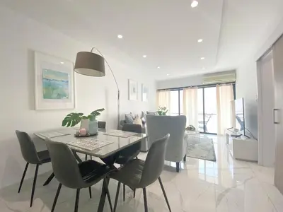 a dining room and living room with a table and chairs at Metro Court Apartments in Limassol