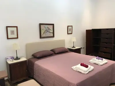 a bedroom with a bed with two towels on it at Avgi's Home in Limassol