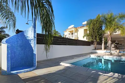 a swimming pool in front of a house at Villa Harmony in Protaras