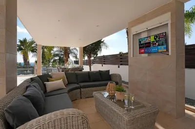 a living room with a couch and a tv at Villa Harmony in Protaras
