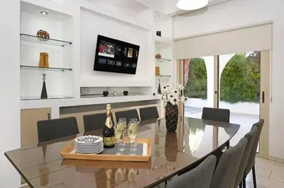 a dining room with a glass table and chairs at Villa Harmony in Protaras