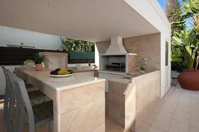 an outdoor kitchen with a island with a counter top at Villa Harmony in Protaras