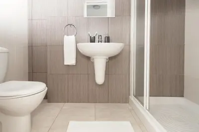 a bathroom with a sink and a toilet and a shower at Amber - Coralli Beachfront Apartment in Protaras