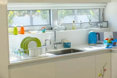 a kitchen counter with a sink and a window at Protaras Villa Zen in Protaras