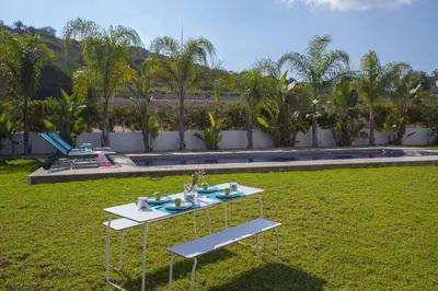 a table in the grass in a yard at Protaras Villa Zen in Protaras