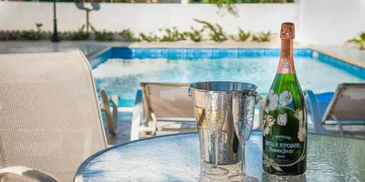 a bottle of champagne sitting on a table next to a bucket at Villa Stefanie in Ayia Napa