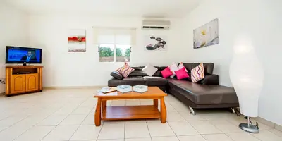 a living room with a couch and a coffee table at Villa Stefanie in Ayia Napa