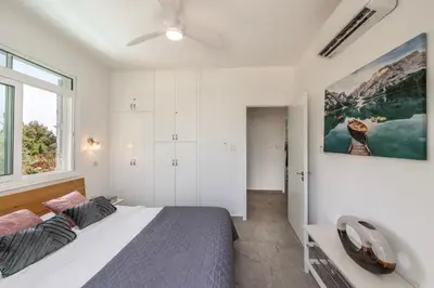 a bedroom with a bed and a large window at Villa Mesogeios 39 in Paralimni