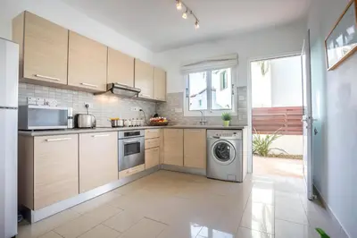 a kitchen with a washer and a washing machine at Villa Costas in Protaras