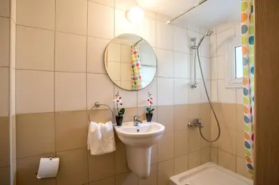 a bathroom with a sink and a mirror at Villa Costas in Protaras