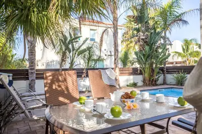 a table with a bowl of fruit on a patio at Villa Costas in Protaras