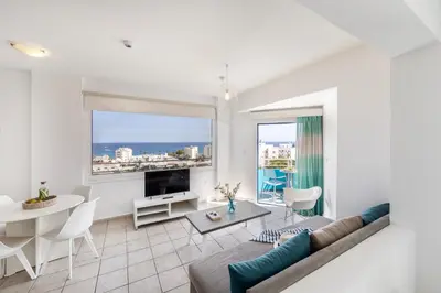 a living room with a couch and a table at Lantiana Gardens ApartHotel in Protaras