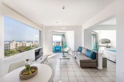 a living room with a couch and a table at Lantiana Gardens ApartHotel in Protaras