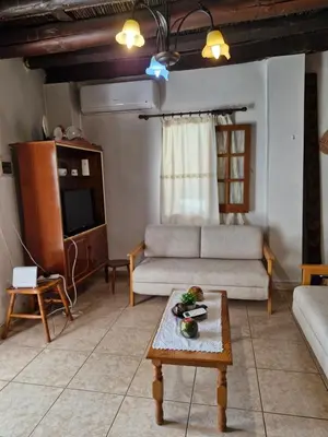 a living room with a couch and a table at John' s House in Omodos in Limassol