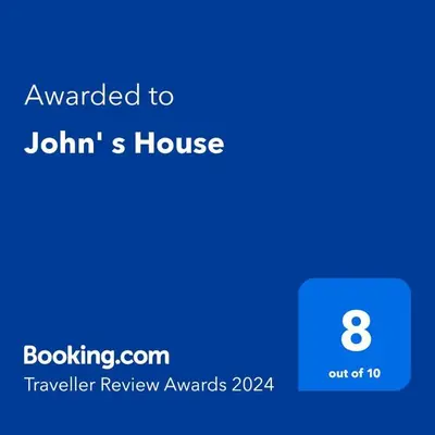 a screenshot of a phone with the text awarded to johanns house at John' s House in Omodos in Limassol